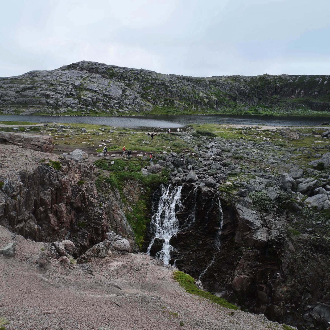 Batareysky waterfall falling toward the sea with the Dragon Eggs stone beach